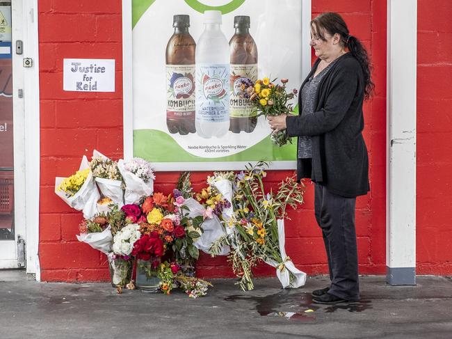 Mary-Anne Clifford stops to lay flowers from her garden at the petrol station. Picture: EDDIE SAFARIK