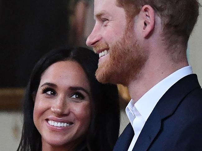 (FILES) In this file photo taken on October 18, 2018 Britain's Prince Harry and Meghan, Duchess of Sussex attend a reception at Government House in Melbourne, Australia. - Prince Harry and his pregnant wife Meghan Markle will move into a historic cottage on the royal family's Windsor Estate early next year, Kensington Palace said on Saturday, November 24, 2018. (Photo by JULIAN SMITH / POOL / AFP)