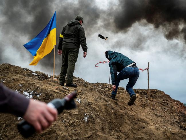 A civilian in Zhytomyr trains to throw Molotov cocktails. Picture: Viacheslav Ratynskyi/Reuters