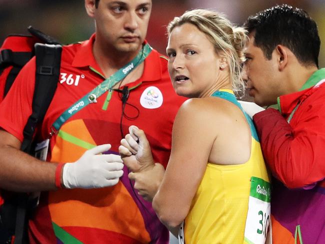 RIO DE JANEIRO, BRAZIL - AUGUST 16: Kim Mickle of Australia is assisted by medical staff after being injured during the Women's Javelin Throw Qualifying Round on Day 11 of the Rio 2016 Olympic Games at the Olympic Stadium on August 16, 2016 in Rio de Janeiro, Brazil. (Photo by Cameron Spencer/Getty Images)