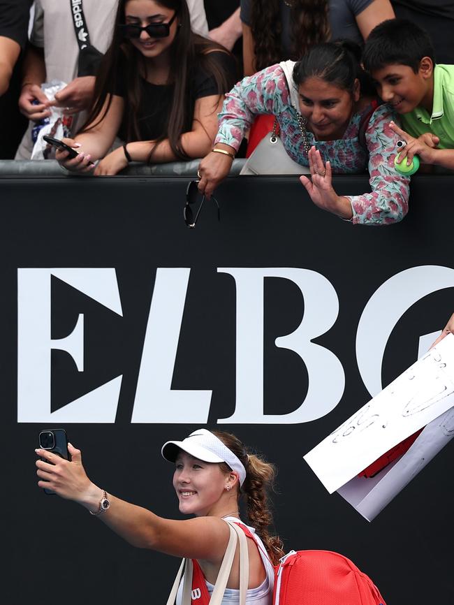 The 17-year-old took a selfie with fans, who she credits for helping her win the round two clash. Picture: Cameron Spencer/Getty Images