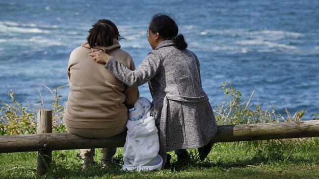 Family being comforted in KiamaPicture: Richard Dobson