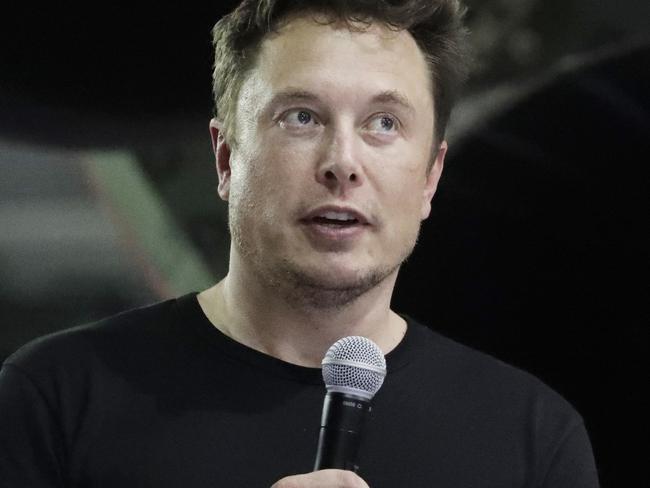 FILE- In this Monday, Sept. 17, 2018, file photo Tesla CEO and SpaceX founder and chief executive Elon Musk speaks after announcing Japanese billionaire Yusaku Maezawa as the first private passenger on a trip around the moon in Hawthorne, Calif. Tesla Inc. has turned over documents to the U.S. Justice Department after statements by Musk about taking the company private, the electric car maker confirmed Tuesday, Sept. 18. (AP Photo/Chris Carlson, File)