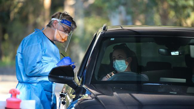 Nurses are seen working at a Covid-19 testing drive through clinic. Picture: NCA NewsWire/ Gaye Gerard