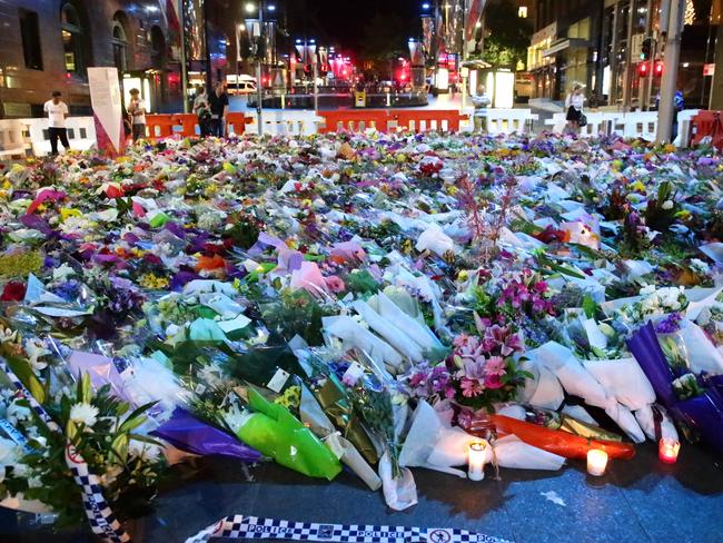 Floral tributes surround the crime scene at Martin Place. Picture: Bill Hearne