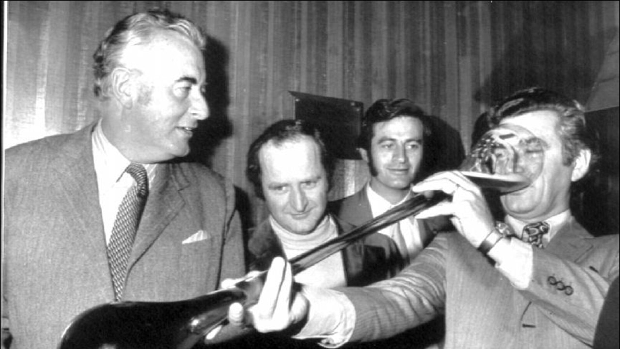 Hawke drinks from a yard glass with Gough Whitlam.