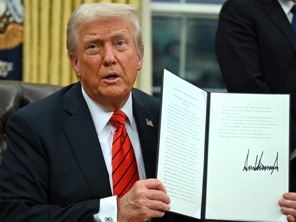 US President Donald Trump has been busy bashing out executive orders in the Oval Office of the White House. Picture: AFP