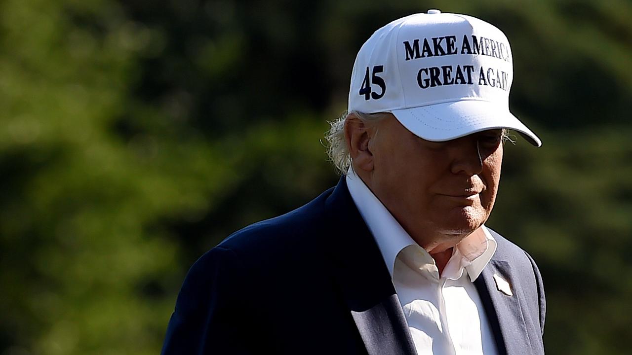 US President Donald Trump walks off Marine One at the White House in Washington, DC after spending the weekend at Bedminster, New Jersey. Picture: Olivier Douliery