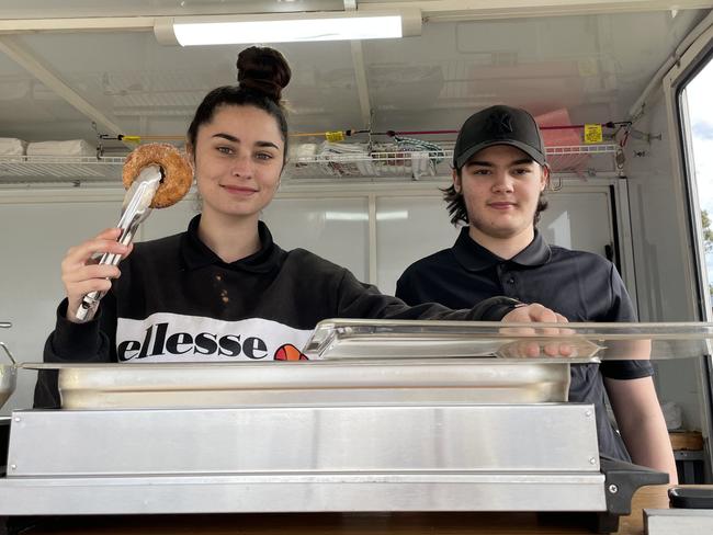 Support worker Jade Young with MyLife participant Sebashian McLean at the new doughnut trailer in Nanango.