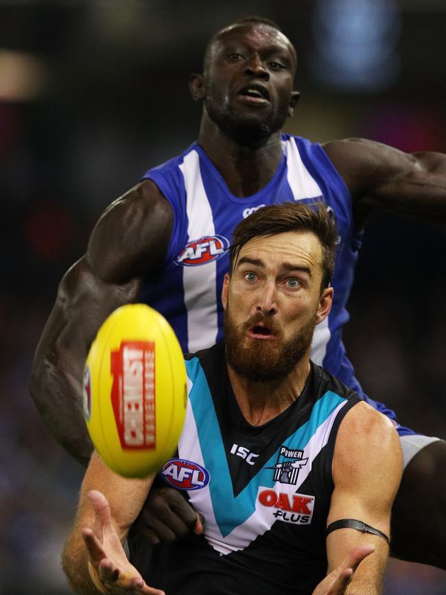 Power’s Charlie Dixon takes a mark in front of North Melbourne’s Majok Daw at Etihad Stadium.