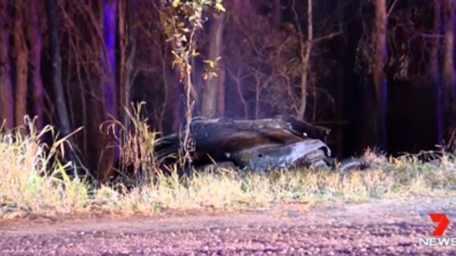 Emergency service workers at the scene of Saturday's double fatality on the Bruce Highway at Kolonga.