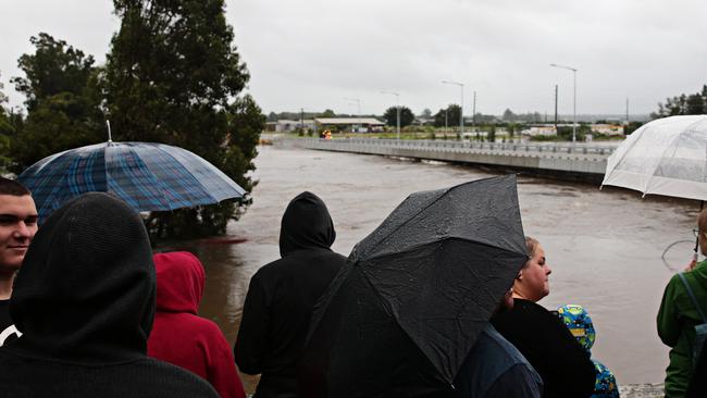 People watching to see when the water rises over the New Windsor bridge. Picture: Adam Yip