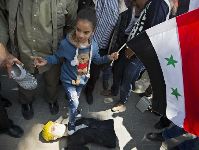 A Palestinian girl holding a Syrian flag tramples on a effigy of  Donald Trump during demonstrations following a wave of US, British and French military strikes to punish President Bashar Assad for suspected chemical attack against civilians.