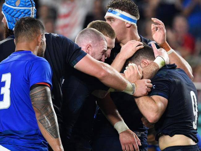 Scotland's scrum-half Greig Laidlaw (right) celebrates with teammates after scoring a try against Samoa. Picture: AFP