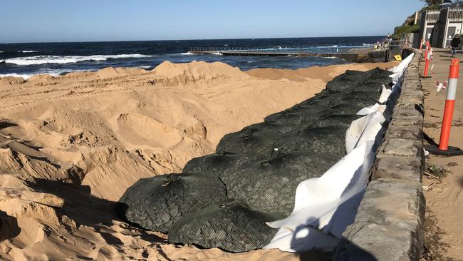 Northern Beaches Council has been placing huge steel mesh bags filled with four tonnes of rock on the seaward side of the sea wall at the southern end of Collaroy Beach. Picture: Manly Daily