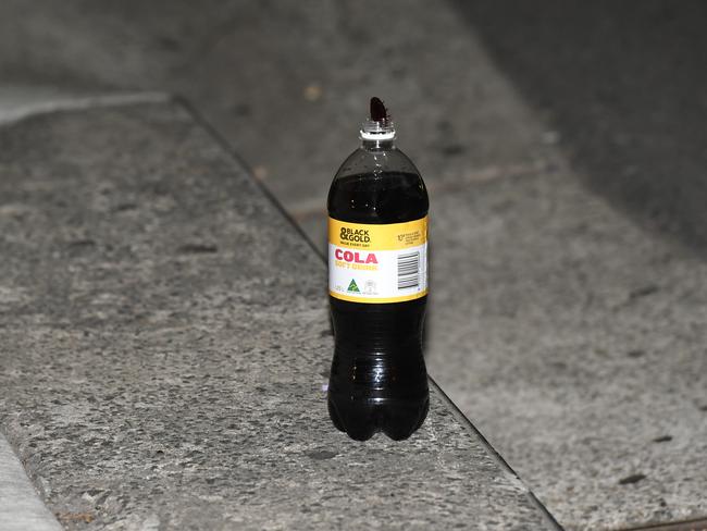 A bottle of black and gold cola is being treated as evidence by police. Picture: Gordon McComiskie