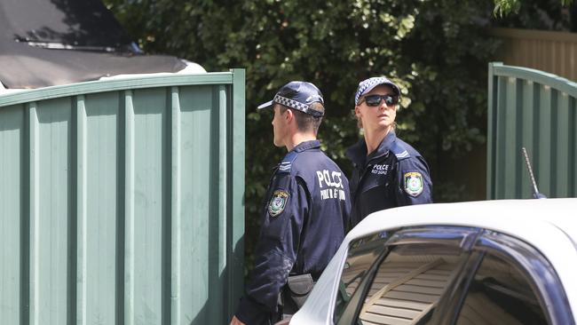 Police at one of the addresses during the raids. Picture: Dylan Robinson