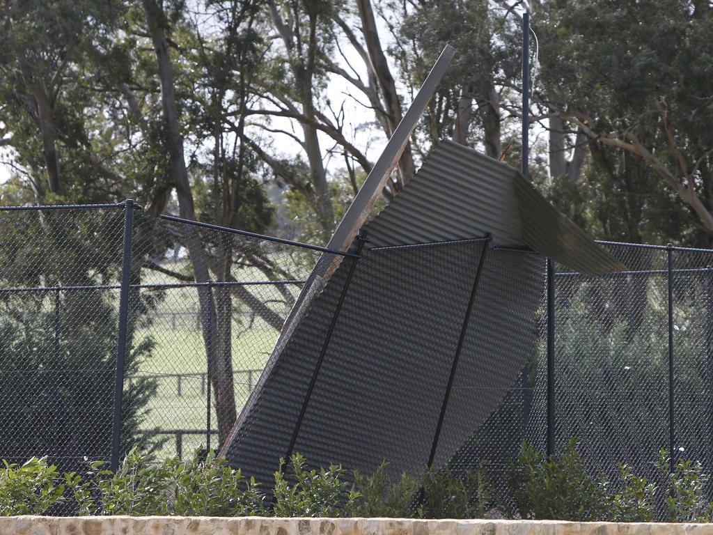 A fence takes the strain of part of a roof that flew off a property near Nairne. Picture: Simon Cross