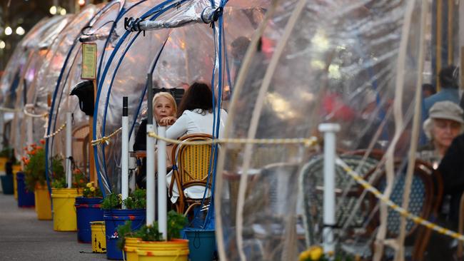 New Yorkers dine in plastic tents at a restaurant in Manhattan. Picture: AFP