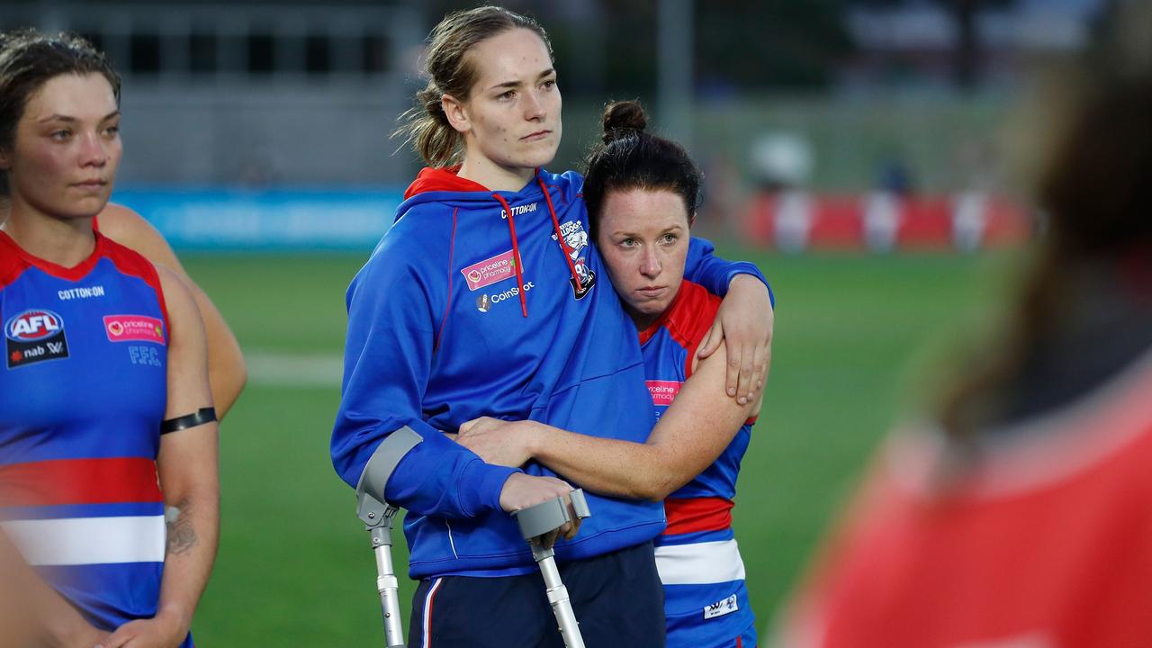 Isabel Hutington is consoled after suffering an ACL injury.