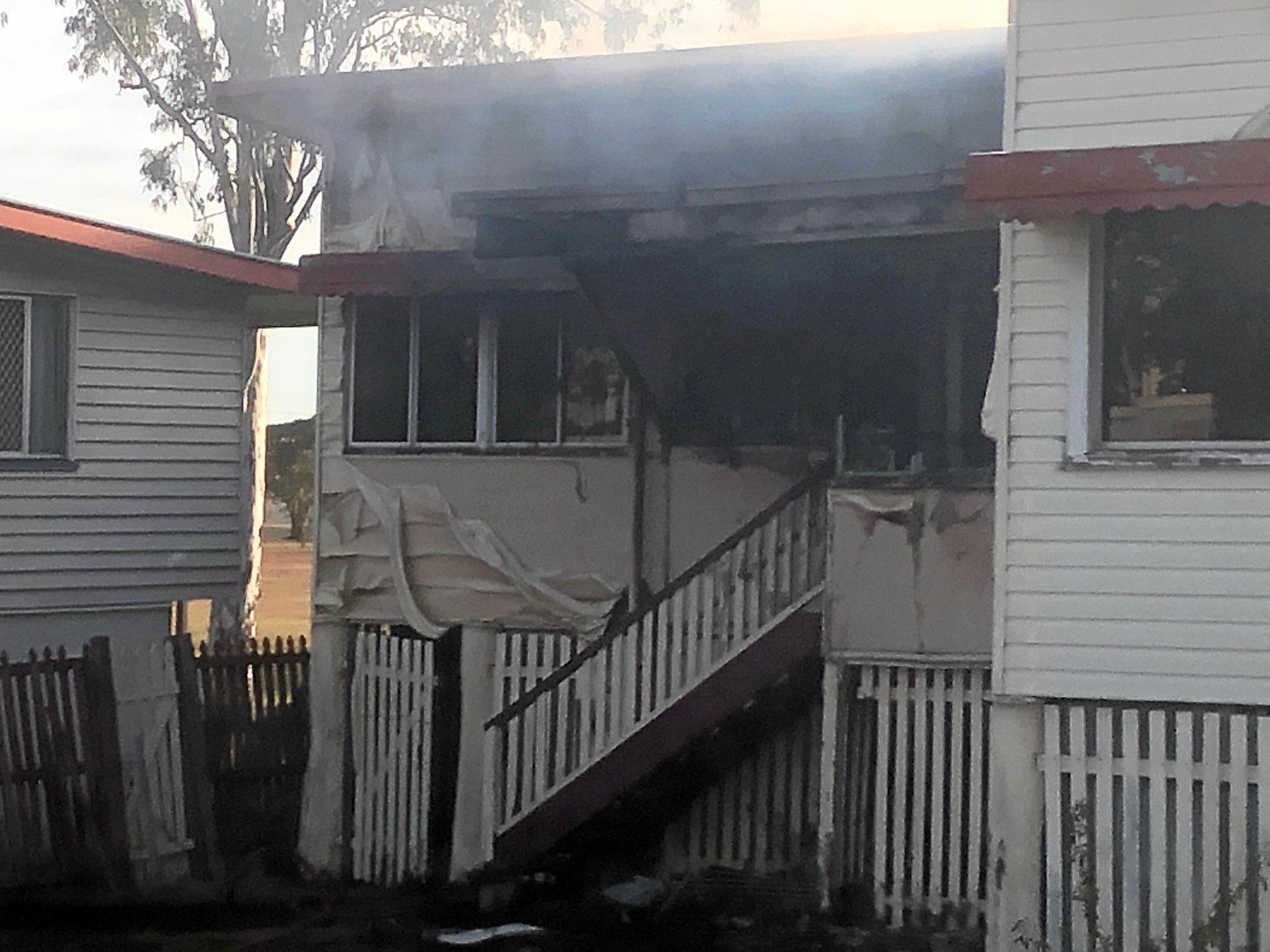 Firefighters at the scene of a house fire on Naughton St, Wandal, this afternoon. Reports indicate the top part of the house is gutted but firefighters are walking in through the front door.