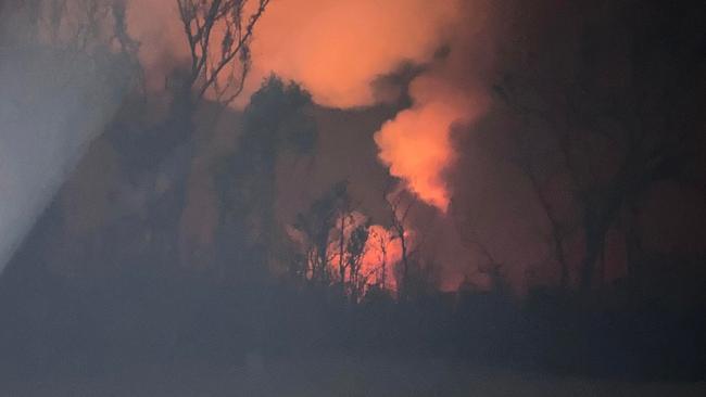 A photo Michelle Cullen took of the bushfire spreading throughout the back of her property on Billabong Lane, Wieambilla before evacuating. photo: contributed