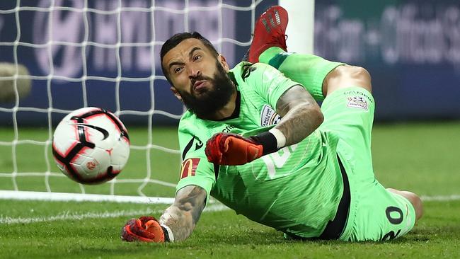 Goalkeeper Paul Izzo saves a penalty during Adelaide United’s preliminary final shootout loss to Perth Glory last campaign. Picture: Paul Kane/Getty Images