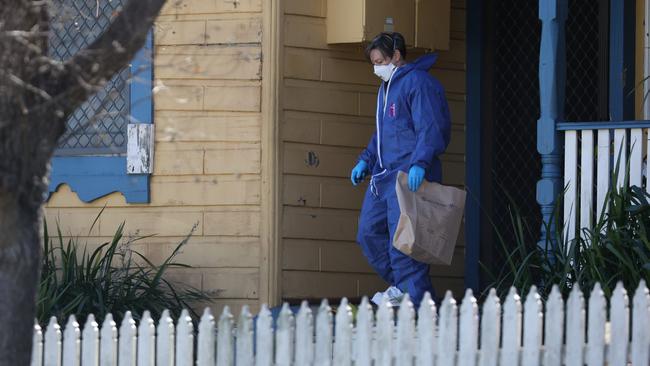 Forensic experts at the house where the man’s body was found. Picture: David Swift