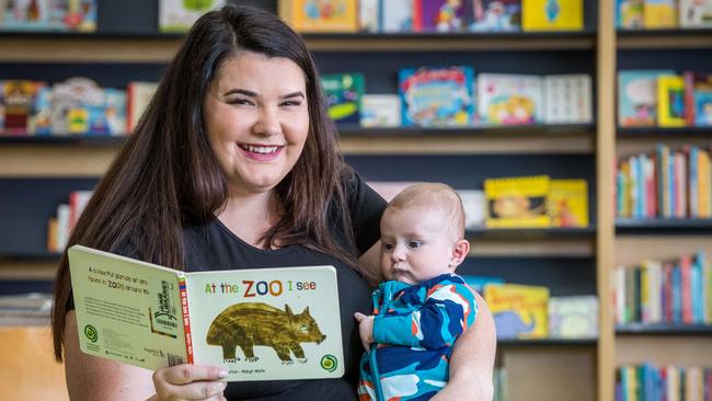 Hayley Schwarze reads to her 13 week old son Mitchell at Craigieburn Library. Picture: Jake Nowakowski