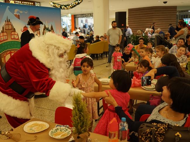 Santa with children and their families.