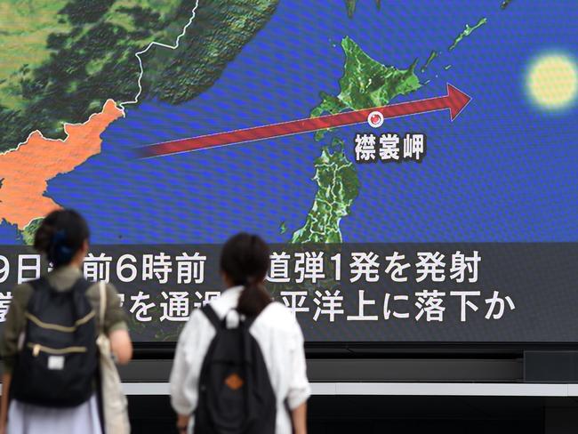 Pedestrians watch the news on a huge screen displaying a map of Japan and the Korean Peninsula following a North Korean missile test that passed over Japan. Picture: AFP