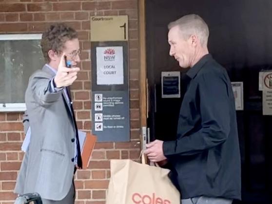 Timothy Murphy (right) talks with his lawyer outside Grafton Local Court.