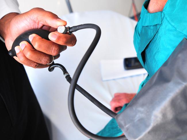 A doctor checks a womans blood pressure at Nambour General Hospital.Photo: Iain Curry / Sunshine Coast Daily