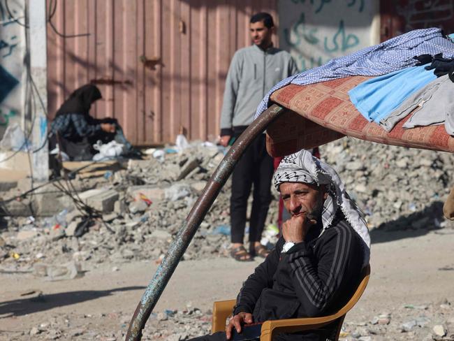 A displaced Palestinian man sits amid the rubble on a street in Rafah in the southern Gaza Strip. The IMF says Palestine’s economy has been ‘devastated.’ Picture: AFP