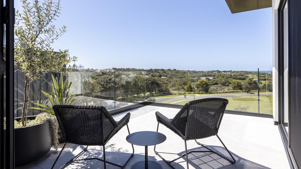 Floor-to-ceiling windows capture breathtaking ocean and golf course views.