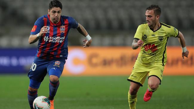 Newcastle’s Dimitri Petratos takes on Reno Piscopo of the Phoenix at Netstrata Jubilee Stadium on Thursday night. Picture: Getty Images