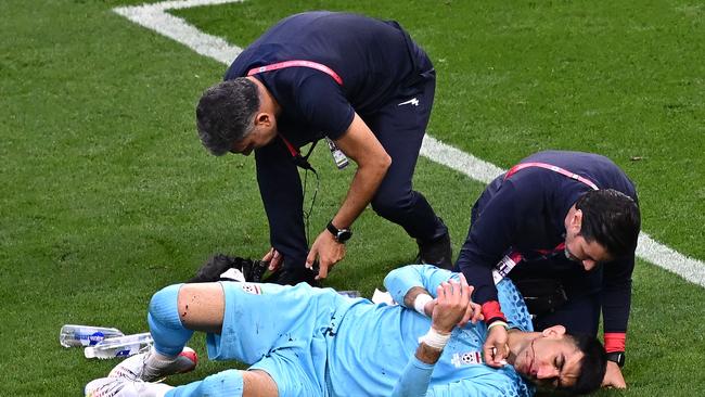 Alireza Beiranvand receives medical attention.