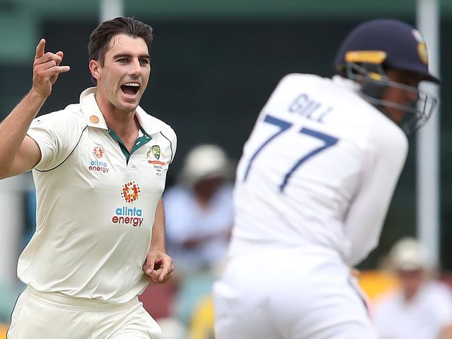 BRISBANE, AUSTRALIA - JANUARY 16: Pat Cummins of Australia celebrates after taking the wicket of Shubman Gill of India during day two of the 4th Test Match in the series between Australia and India at The Gabba on January 16, 2021 in Brisbane, Australia. (Photo by Jono Searle/Getty Images)