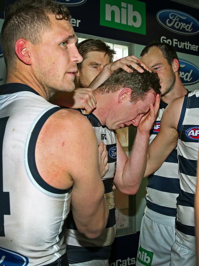 Steve Johnson is consoled by teammates after singing the Cats song for the last time. Picture: Colleen Petch