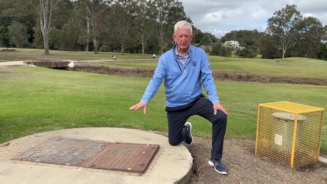 Meadowbrook Golf Club managing director Tom Linskey shows a sewer value and concrete manhole Logan City Council built in the middle of the fairway.