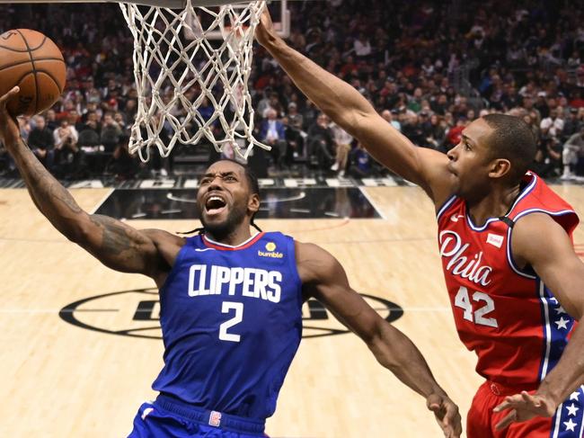 Los Angeles Clippers forward Kawhi Leonard, left, shoots as Philadelphia 76ers forward Al Horford defends during the second half of an NBA basketball game Sunday, March 1, 2020, in Los Angeles. The Clippers won 136-130. (AP Photo/Mark J. Terrill)