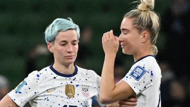 Megan Rapinoe and Kristie Mewis react to the shock loss. Photo by WILLIAM WEST / AFP