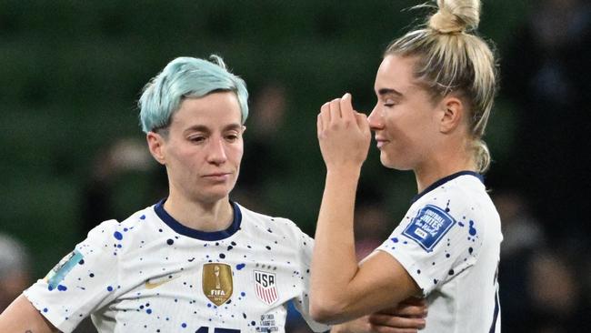 Megan Rapinoe and Kristie Mewis react to the shock loss. Photo by WILLIAM WEST / AFP