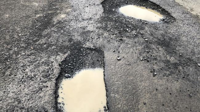 We counted more than 10 pot holes in this Campsie car park. Picture: Lawrence Machado