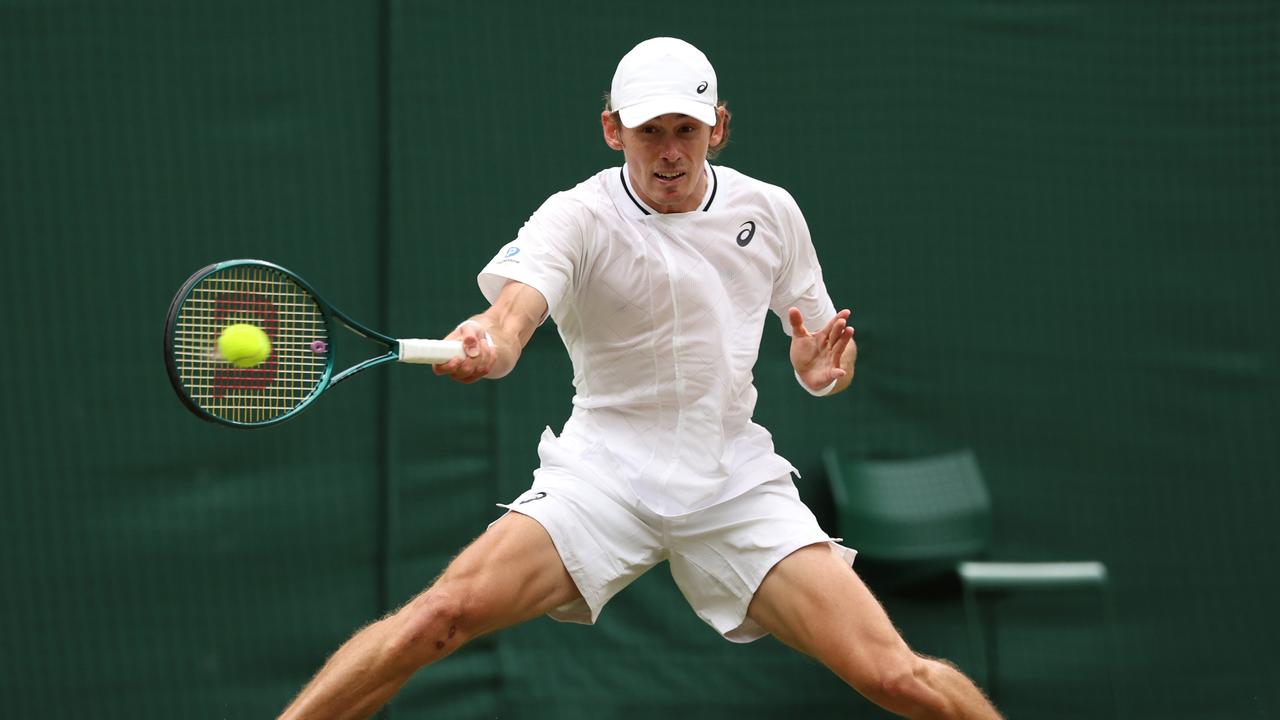 LONDON, ENGLAND – JULY 08: Alex de Minaur of Australia slides to play a forehand against Arthur Fils of France in his Gentlemen's Singles fourth round match during day eight of The Championships Wimbledon 2024 at All England Lawn Tennis and Croquet Club on July 08, 2024 in London, England. (Photo by Sean M. Haffey/Getty Images)