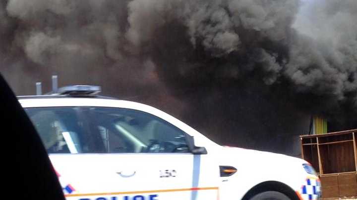 Bec Williamson captures smoke billowing from Sun Pine Furniture.