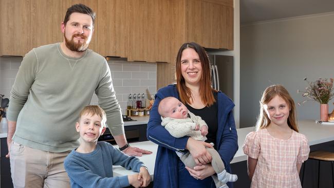 The Edson family – Jordan, Daxon, 6, Kaela with son Angus, 2 months, and Lauren, 8 – inside their new home at Liberty Estate, Two Wells. Picture: Russell Millard