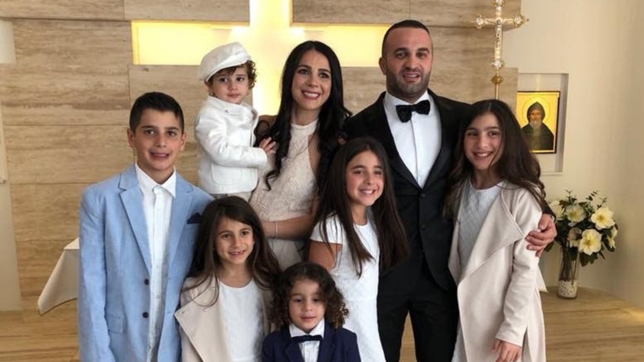 Antony (far left), Sienna, (second left on bottom) and Angelina (far right) with their parents.