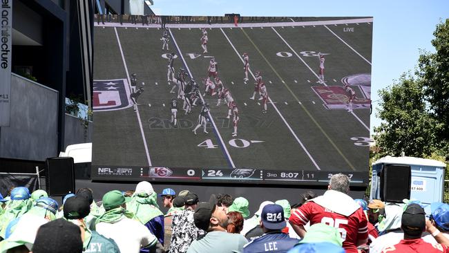 Australia could benefit by putting on more live sports games on big screens at local parks (pictured a Superbowl watch party in Melbourne). Picture: NewsWire / Andrew Henshaw