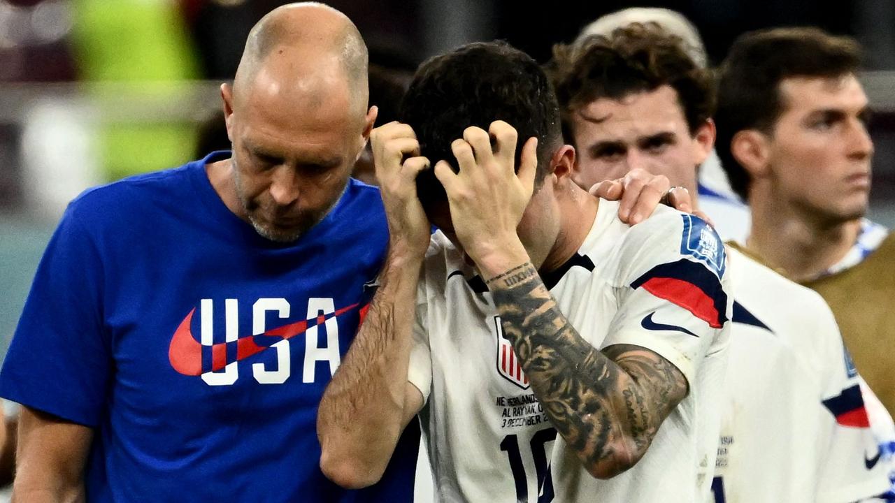 USA's coach Gregg Berhalter (L) and USA's forward #10 Christian Pulisic react at the end of the match.